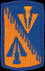 Embroidered patch with orange and blue design on a blue background