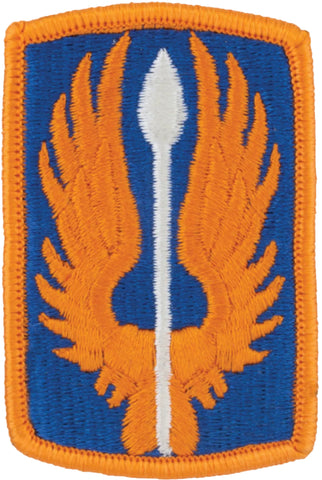 Embroidered patch with orange flames and a white spear on a blue background