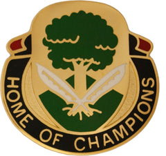 Metal pin unit crest with green tree and two white feather pen 