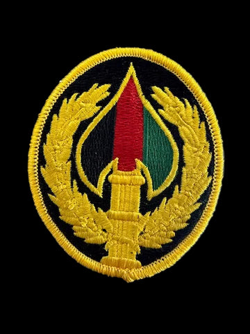 Embroidered patch with a circular design on a black textured background