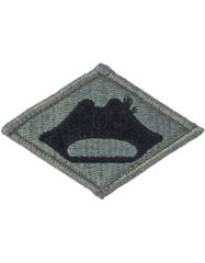 Diamond-shaped patch with a black silhouette of a hat on a gray  green background