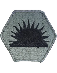 Hexagonal patch with a black sun-like design on a gray background