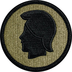 Circular patch with black silhouette of a profile on a green background