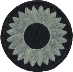 Circular patch with green sunflower design on a black background