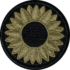 Embroidered sunflower patch on a black background