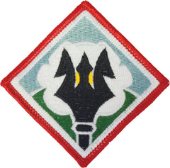 Embroidered patch with a black and yellow design on a white background