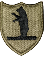 Patch with a black bear silhouette on a brown shield shape