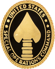 oval metal pin with black background and a gold emblem in the middle and letter around United States Special Operations Command