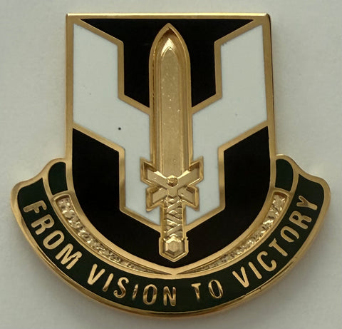 metal unit crest with a gold sword.