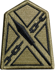 Green patch with black geometric design on a white background